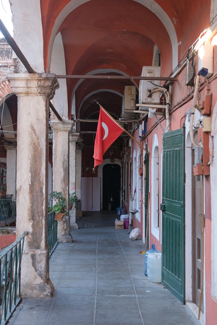 Corridor with Turkish flag, showcasing classic architecture details.